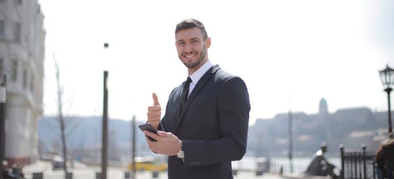 Businessman giving thumbs up for Kansas long distance movers