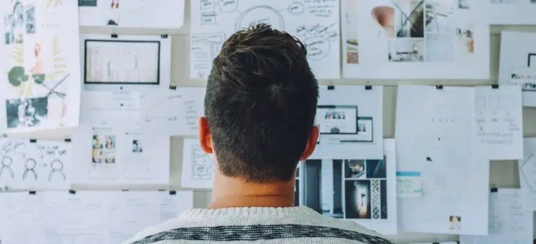 a man looking at a plan on the wall